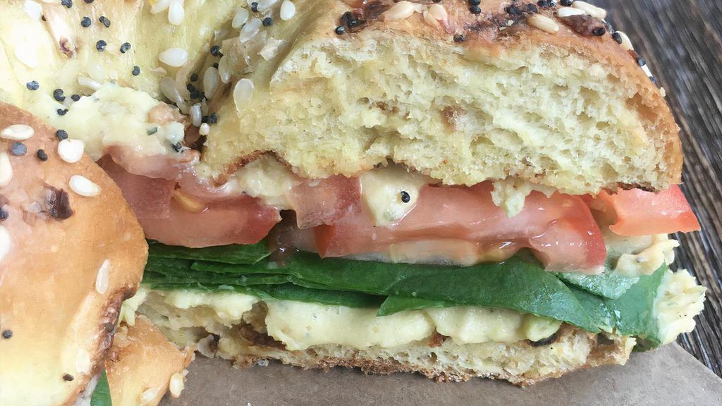 Bagel With Hummus, Tomato And Spinach · In house made hummus with tomato and baby spinach on your choice of bagel.