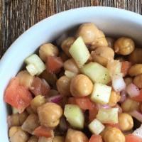 Chickpea Salad · Baked chickpeas, tomato, onion, and cucumbers in a zesty cumin dressing.