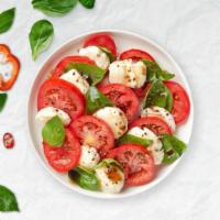 Caprese Angel Salad · Romaine, fresh mozzarella, tomatoes, topped with fresh basil tossed in your favorite choice ...