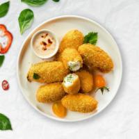 Jalapeño Poppers · Fresh jalapenos coated in cream cheese and fried until golden brown.