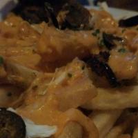 Crab Fries · Fresh crab, house-made cheese sauce, jalapeño, old bay