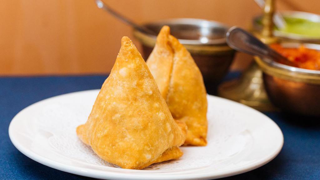 Samosa · Crispy pastry turnover filled with ground lamb or vegetables.