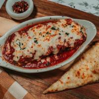 Homemade Lasagna · Pasta layers in marinara with sauteed ground beef, mozzarella, and ricotta cheese.
