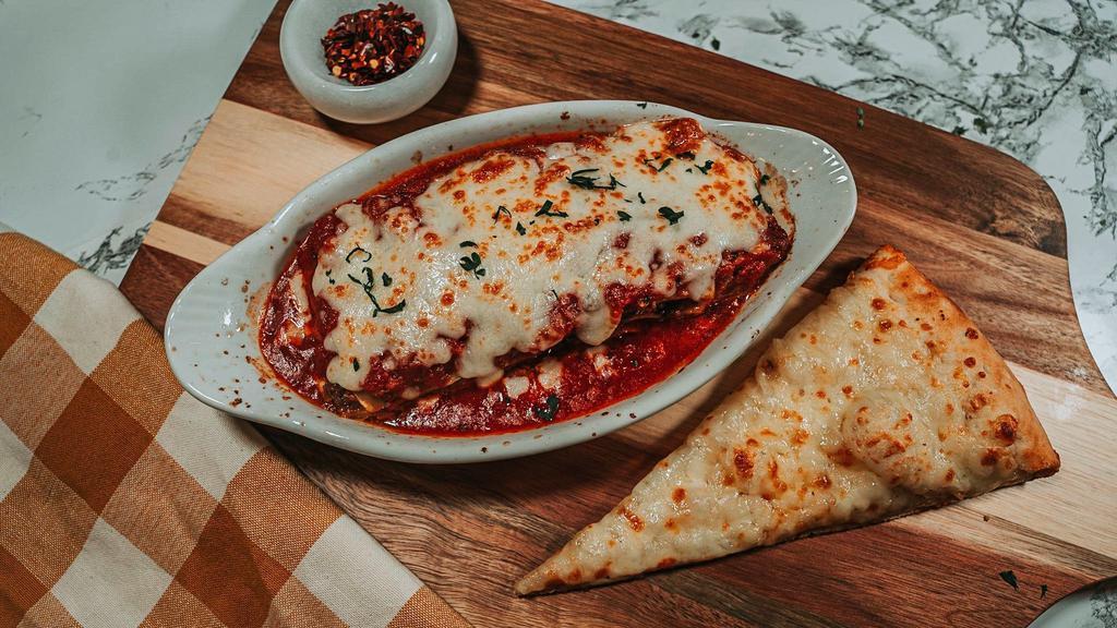 Homemade Lasagna · Pasta layers in marinara with sauteed ground beef, mozzarella, and ricotta cheese.
