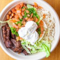 Steak Tip Bowl · Served with rice, lettuce, pinto beans, pico de gallo and sour cream.