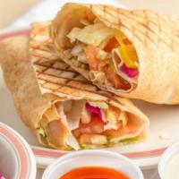 Shawarma Chicken Hummus Wrap · Shaved marinated chicken breast, hummus, tahini sauce wrapped in a white pita, pressed and t...