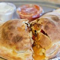 * Buffalo Chicken Calzone · Chicken tenders, caramelized onions, roasted red peppers, roasted garlic and Gorgonzola chee...