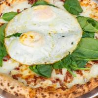 Brunch Pizza · Four cheese blend, chopped bacon, spinach, fried soft egg, and truffle oil.