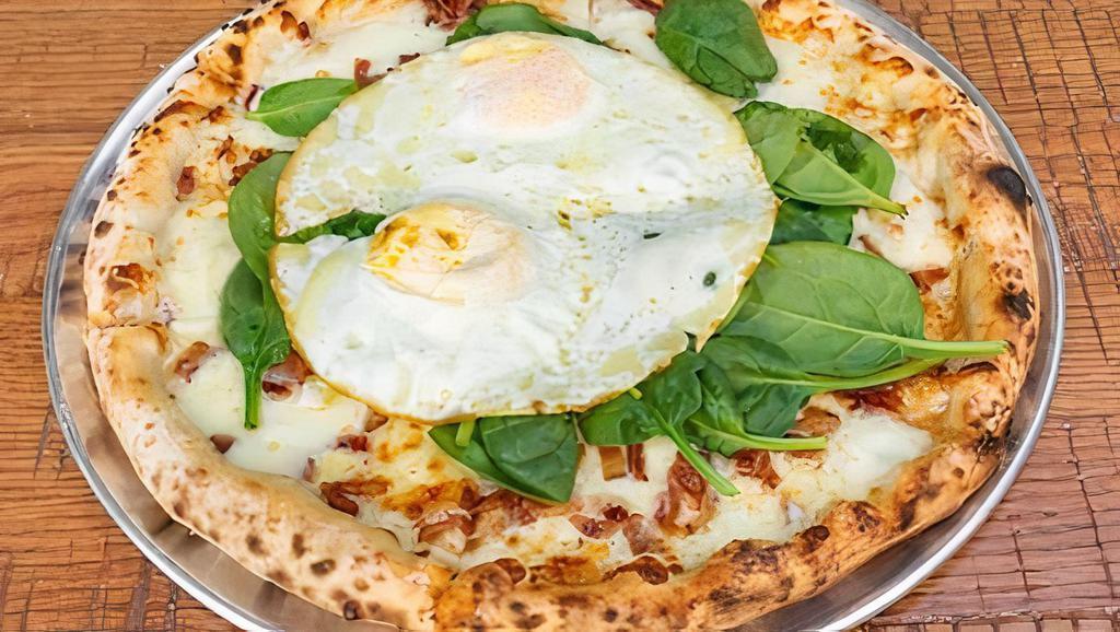 Brunch Pizza · Four cheese blend, chopped bacon, spinach, fried soft egg, and truffle oil.
