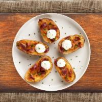 Potato Skins With Bacon & Cheddar · Baked potato skins filled with cheddar cheese, bacon, scallions, and topped with sour cream.