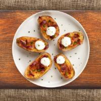 Plain Potato Skins · Baked potato skins filled with cheddar cheese, bacon, scallions, and topped with sour cream.