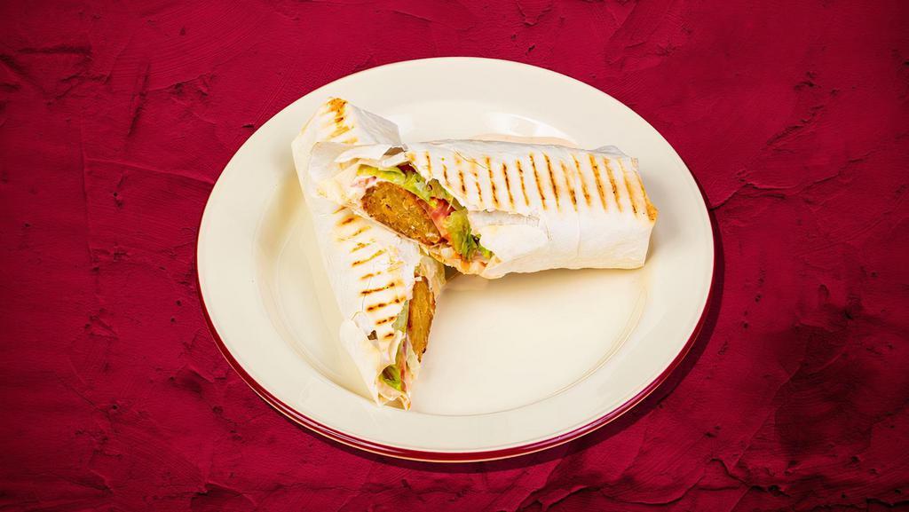 Signature Falafel Shawarma Wrap · Pita layered with ground chickpeas, tahini sauce, falafel, hummus, and pickles
