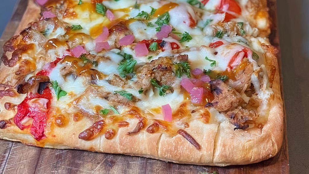 Jamaican Jerk Flatbread · Smoked Jerk Chicken, Caramelized Onions, Red Peppers, Pickled Red Onions, Parsley, Pineapple Habernaro Glaze
