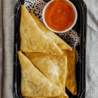 Crab Rangoon · Crispy wonton skin, crab meat, onion, scallion and cream cheese with chili jam dipping sauce.