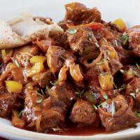 Awaze Tibs · A strip of beef sautéed in seasoned butter, hot peppers, onions, and awaze paste; served on ...