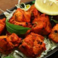 Tandoori Chicken Tikka · Succulent pieces of boneless chicken rubbed with Indian herbs and spices and marinated with ...