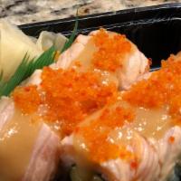 Sunburn Maki · Sea scallop tempura, avocado, spicy mayonnaise topped with torched salmon, and black tobiko....