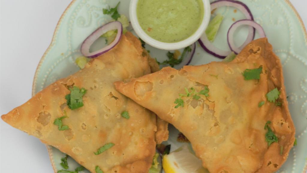 Vegetable Samosa · Seasoned potatoes, green peas and house spices wrapped in a light deep fried pastry dough. one order contains 2 veggie samosas.