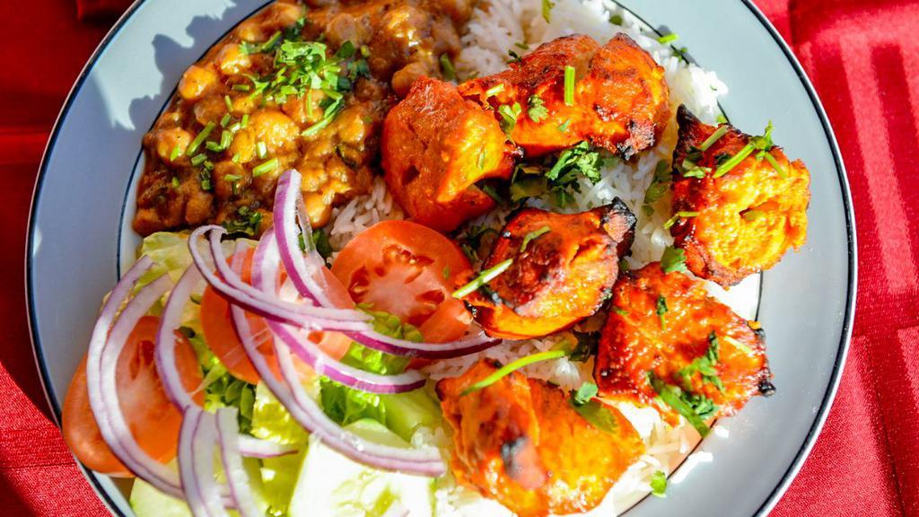 Boneless Chicken Kabob · 6 pieces Tender marinated chicken breasts in house spices, grilled and served with basmati rice, chickpeas, naan (bread) salad and house spices.