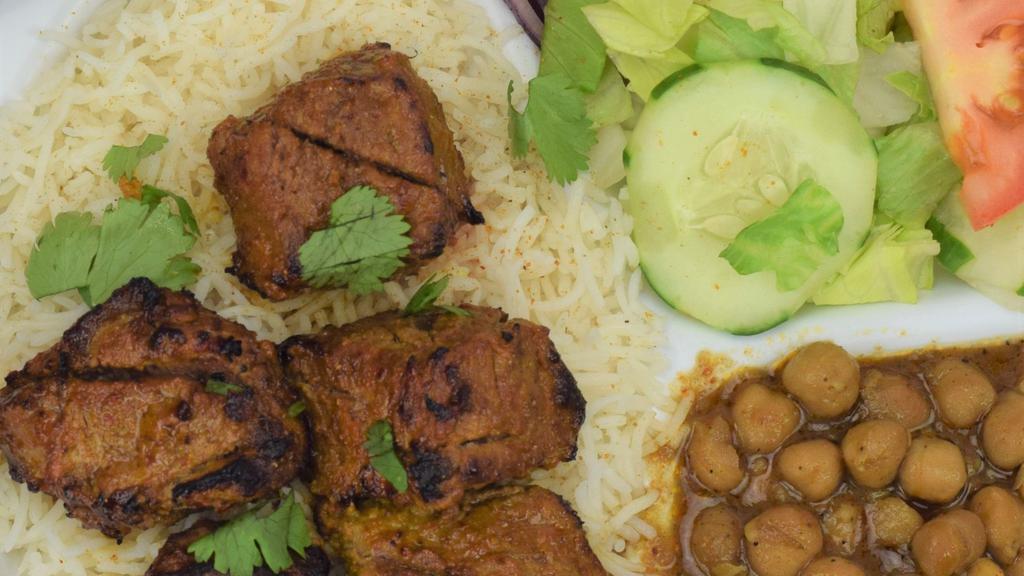 Lamb Kabob · 5 pieces Tender marinated lamb in house spices, grilled and served with basmati rice, chickpeas, naan, salad and house spices.