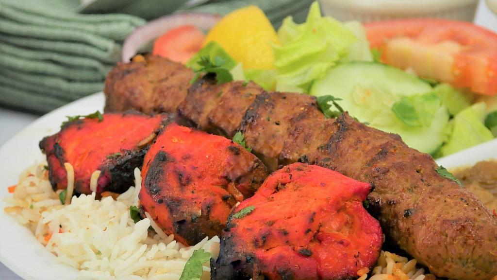 City Combo#1 · 3 pieces of boneless chicken 1 skewer of sheekh kabob .  served with basmati rice, chickpeas, salad 1 naan bread and sauces.