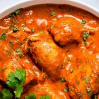 Chicken Tikka Masala · Barbecued chicken cooked in tomato sauce, served with basmati rice.