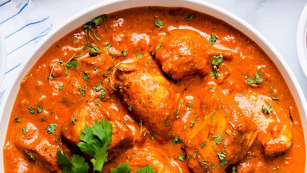 Chicken Tikka Masala · Barbecued chicken cooked in tomato sauce, served with basmati rice.