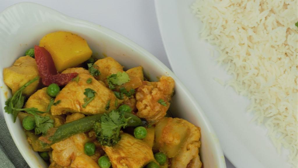 Chicken Jalfraize · Chicken cooked with fresh tomatoes, onions, green peppers, and house spices, served with basmati rice.