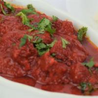 Lamb Rogangosh · Lamb cooked with fresh tomatoes, onions, ginger, garlic, and house spices, served with basma...