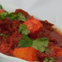 Lamb Vindaloo · Lamb and potatoes cooked in fiery hot sauce and house spices, served with basmati rice.