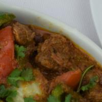 Lamb Kadai · Lamb cooked with fresh ginger, garlic cilantro, diced tomatoes, with house spices, served wi...