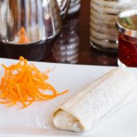 Peking Duck Roll · Chinese roasted crispy duck meat and skin served with scallion cucumber and house sauce in a...