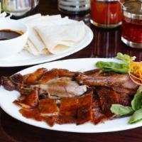 Famous Peking Duck · Fillet of boneless duck served with pancake, scallion in hoisin sauce. Served with steamed r...