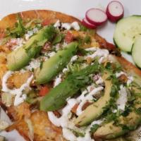 Huaraches · Steak, al pastor, chorizo or chicken topped with refried beans, blend of cheese, lettuce, fr...