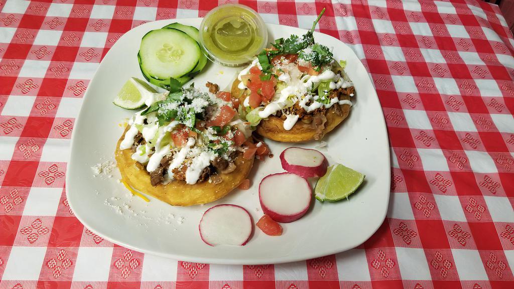 Sopes · Steak, al pastor, chicken or chorizo topped with refried beans, fresh lettuce, pico, and sour cream.