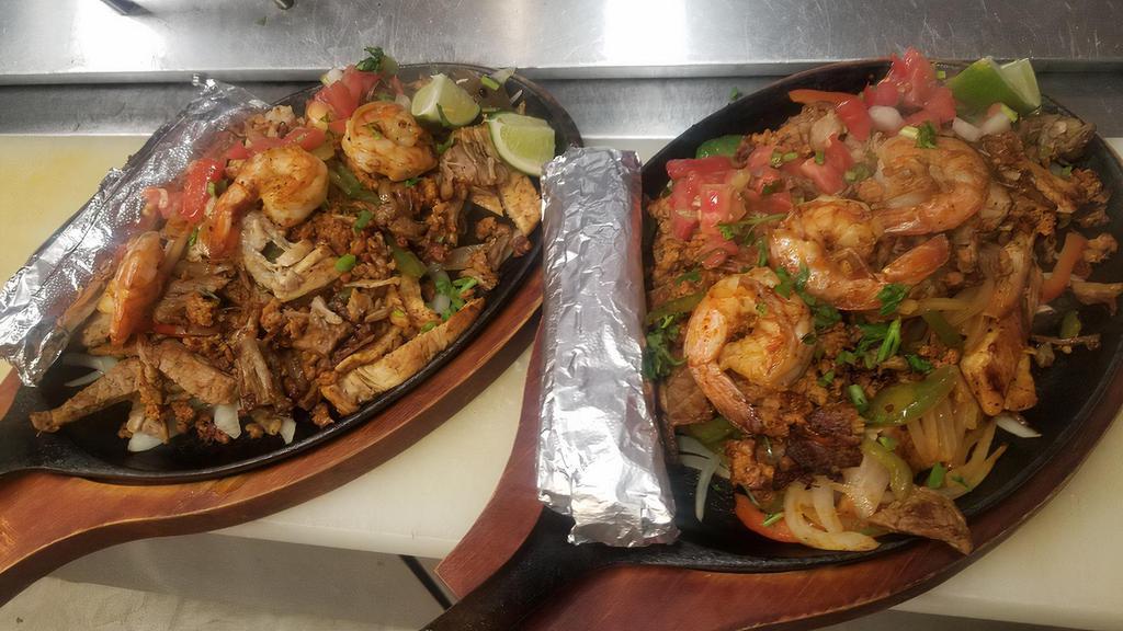 Paraiso Rosel Fajitas · delicious fajitas mix with chicken,steak,shrimp,chorizo and carnitas!! served with rice,  bean on the side and a small salad