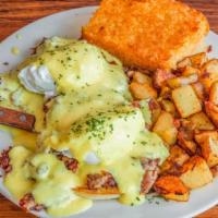 Irish Eggs Benedict · A grilled English muffin topped with homemade hash, two poached eggs, and hollandaise sauce.