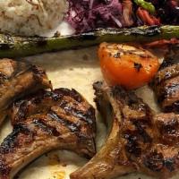 Lamb Chops · Grilled baby lamb, seasoned to perfection served with vegetables over rice.