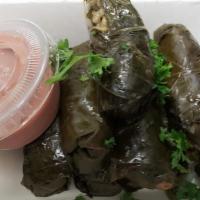 Stuffed Grape Leaves · Eight grape leaves stuffed with rice and spice, topped with lemon juice and parsley, comes w...