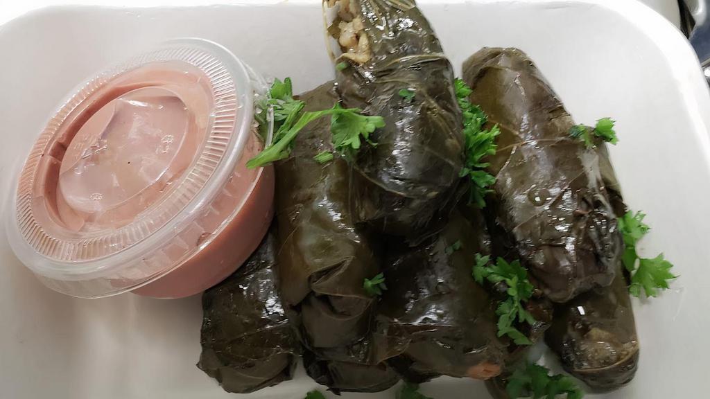 Stuffed Grape Leaves · Eight grape leaves stuffed with rice and spice, topped with lemon juice and parsley, comes with tahini sauce. Gluten free.