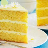 Lemon Cake · A slice of our fresh made tender lemon sponge cake.