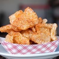 Pork Rinds · Fried and dusted with house rub.