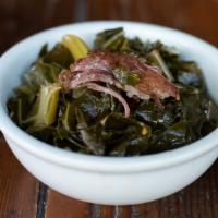Collard Greens · Slow simmered with onions, spices and smoked pork ribs.