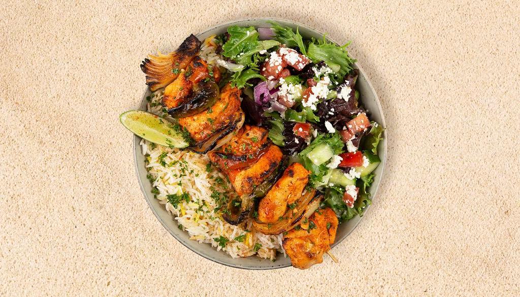 Chicken Kabob Plate · Served with seasoned rice and a salad of mixed greens, tomatoes, and cucumber.