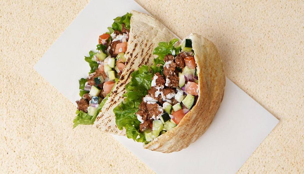 Beef Kabob Pita Sandwich · Wrapped in a pita with lettuce, cucumber, tomato, and your choice of sauce.