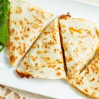 Quesadilla · Flour tortilla with cheese, served with pico de gallo, lettuce and sour cream.