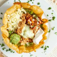 Taco Salad · Beef or chicken, served with sour cream, guacamole and re-fried beans, in a taco shell.