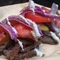 Lamb\Beef Gyro Wrap · Flavorful beef gyro with a garlic sauce, tomatoes, pickles and onions. All wrapped in a fres...
