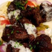 Lebanese Beef Kabob Wrap · Kabobs of mildly spiced beef chunks. Served with hummus, tahini sauce, tomatoes, pickles and...