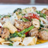 Rigatoni Agli Olio · Sweet Italian sausage, broccoli rabe, roasted peppers in a roasted garlic sauce topped with ...